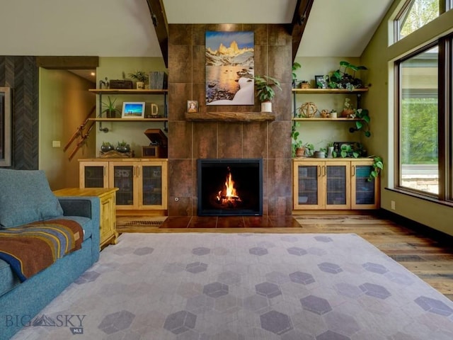 65 Triple Tree Ln, Bozeman, MT 59715 - living area with wood finished floors, vaulted ceiling, and a fireplace