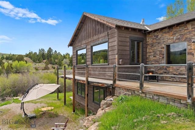 1511 Mt Highway 287, Virginia City, MT 59755 - view of side of property with stone siding and a deck