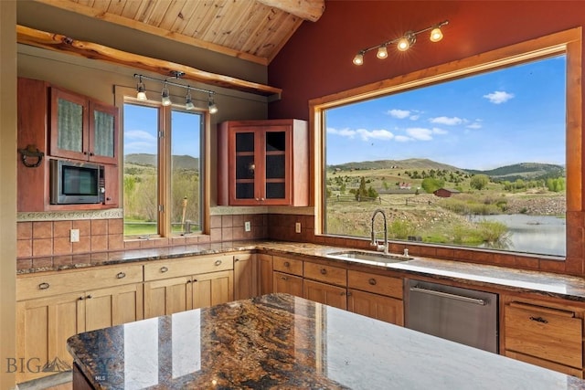 1511 Mt Highway 287, Virginia City, MT 59755 - kitchen featuring stainless steel appliances, a sink, a mountain view, wood ceiling, and dark stone counters