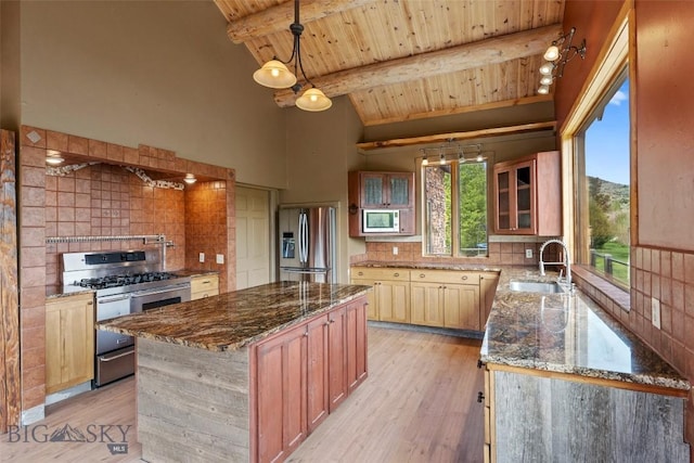 1511 Mt Highway 287, Virginia City, MT 59755 - kitchen featuring stainless steel appliances, wooden ceiling with exposed beams, a sink, dark stone counters, and backsplash