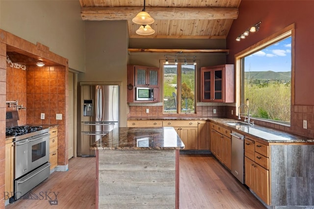 1511 Mt Highway 287, Virginia City, MT 59755 - kitchen featuring stainless steel appliances, a sink, dark stone counters, wooden ceiling, and decorative backsplash