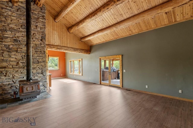 1511 Mt Highway 287, Virginia City, MT 59755 - unfurnished living room featuring a wood stove, wood ceiling with exposed beams, healthy amount of natural light, high vaulted ceiling, and wood finished floors