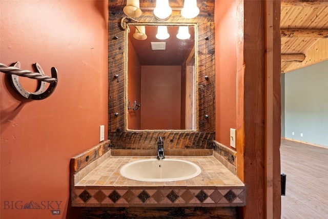 1511 Mt Highway 287, Virginia City, MT 59755 - bathroom with a sink, wooden ceiling with exposed beams, and wood finished floors
