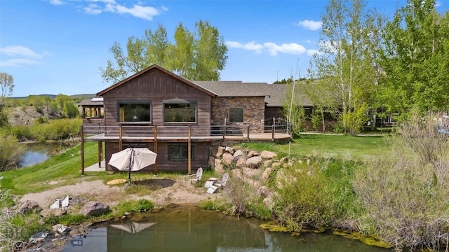 1511 Mt Highway 287, Virginia City, MT 59755 - back of property with stone siding, a deck, and a lawn