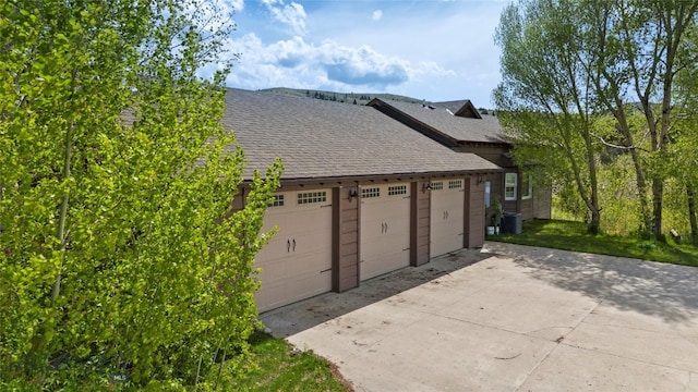 1511 Mt Highway 287, Virginia City, MT 59755 - view of home's exterior with a garage, a shingled roof, and cooling unit