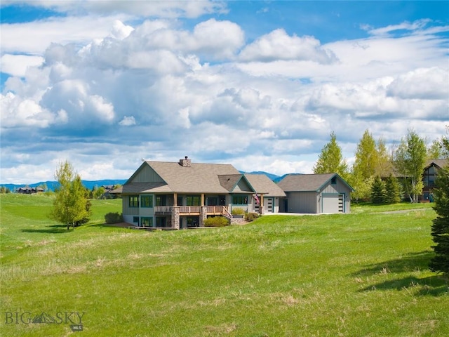 101 Columbine Ct, Bozeman, MT 59715 - rear view of house featuring an attached garage, a lawn, and a chimney