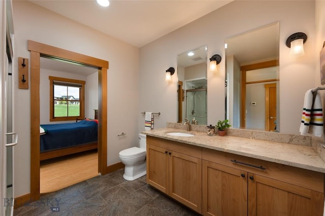 101 Columbine Ct, Bozeman, MT 59715 - ensuite bathroom featuring vanity, toilet, a shower with door, and baseboards