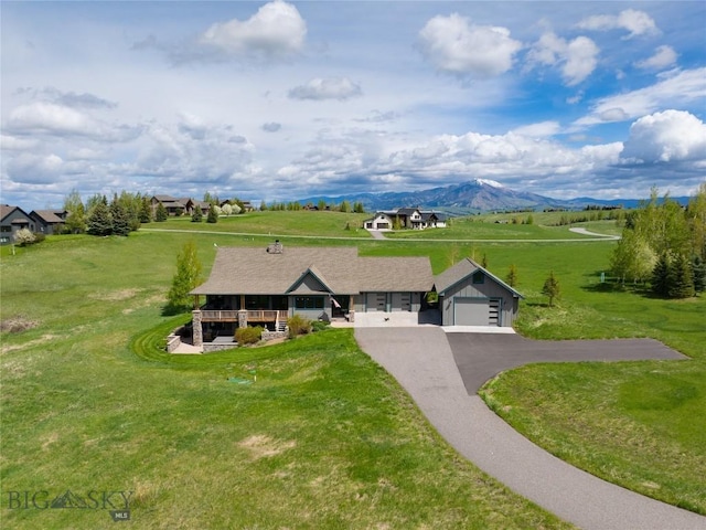101 Columbine Ct, Bozeman, MT 59715 - view of front of house featuring asphalt driveway, a front yard, and a mountain view