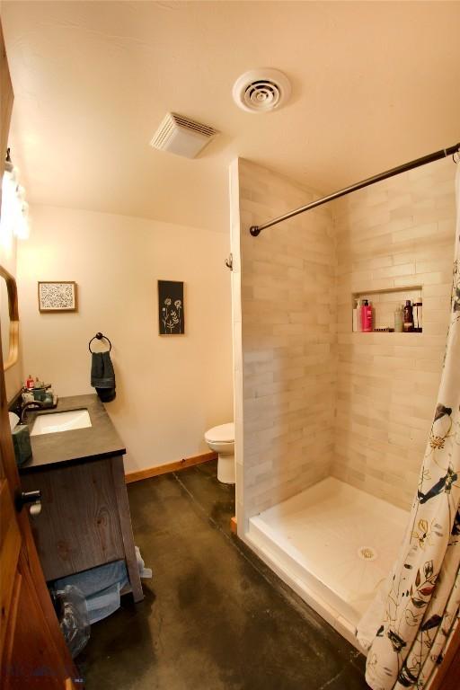 191 Rolling Prairie & Way, Three Forks, MT 59752 - full bathroom with a tile shower, toilet, concrete flooring, and vanity