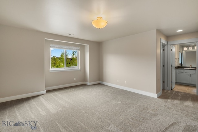 3123 Warbler Way Units A-D, Units A-D Bozeman, MT 59718 - empty room with light carpet, baseboards, and a sink
