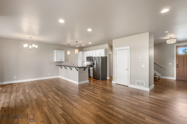 3123 Warbler Way Units A-D, Units A-D Bozeman, MT 59718 - unfurnished living room featuring a chandelier, recessed lighting, dark wood-type flooring, stairway, and baseboards