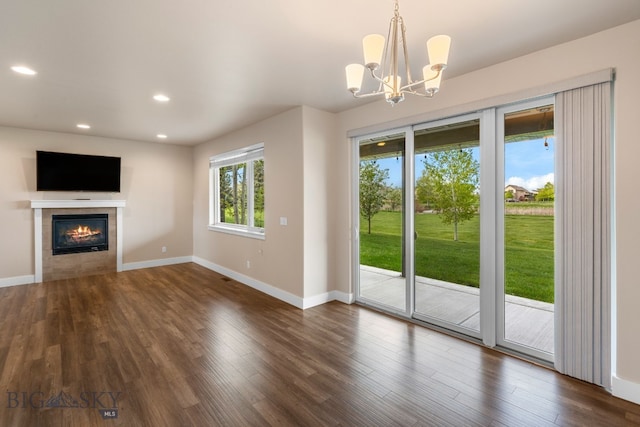 3123 Warbler Way Units A-D, Units A-D Bozeman, MT 59718 - unfurnished living room with baseboards, a tiled fireplace, recessed lighting, dark wood-type flooring, and a chandelier