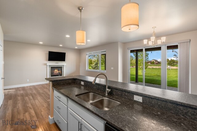 3123 Warbler Way Units A-D, Units A-D Bozeman, MT 59718 - kitchen with a sink, baseboards, wood finished floors, decorative light fixtures, and recessed lighting