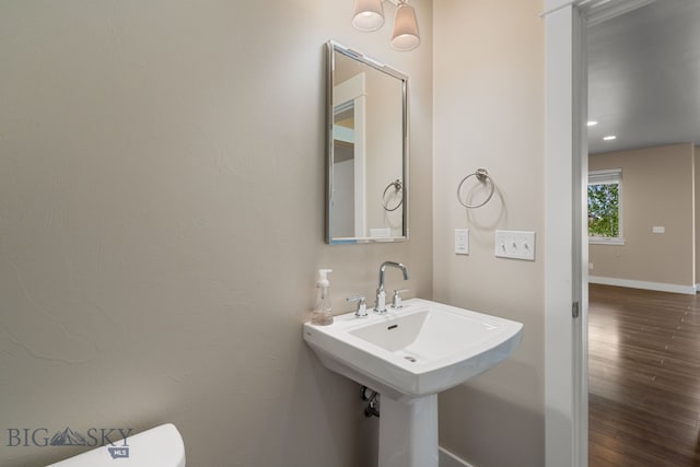 3123 Warbler Way Units A-D, Units A-D Bozeman, MT 59718 - bathroom featuring wood finished floors, toilet, baseboards, and a sink