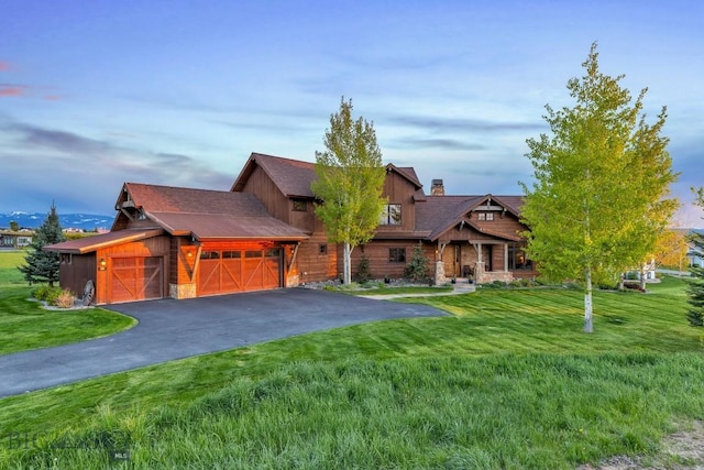 171 Brave Heart Loop, Bozeman, MT 59718 - log cabin with a front yard, a chimney, stone siding, and asphalt driveway