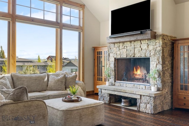 171 Brave Heart Loop, Bozeman, MT 59718 - living room featuring vaulted ceiling, wood finished floors, and a stone fireplace