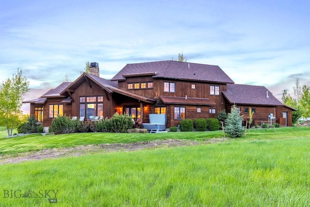 171 Brave Heart Loop, Bozeman, MT 59718 - back of property featuring a chimney and a lawn