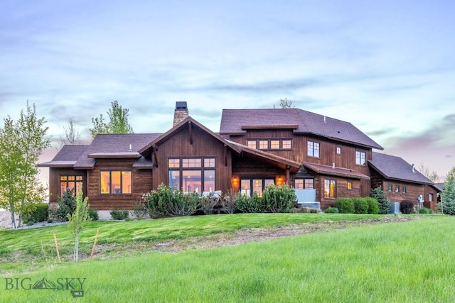 171 Brave Heart Loop, Bozeman, MT 59718 - rear view of house featuring a chimney and a lawn