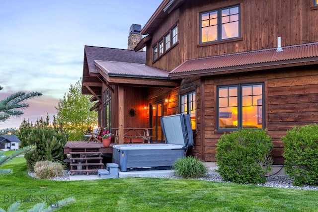 171 Brave Heart Loop, Bozeman, MT 59718 - back of house at dusk with a yard, metal roof, and a chimney