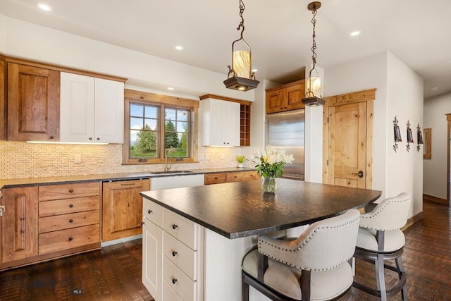 171 Brave Heart Loop, Bozeman, MT 59718 - kitchen with a sink, decorative backsplash, dark wood-style floors, dark countertops, and recessed lighting