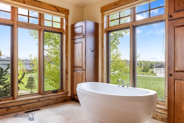 171 Brave Heart Loop, Bozeman, MT 59718 - bathroom featuring a freestanding tub and tile patterned flooring