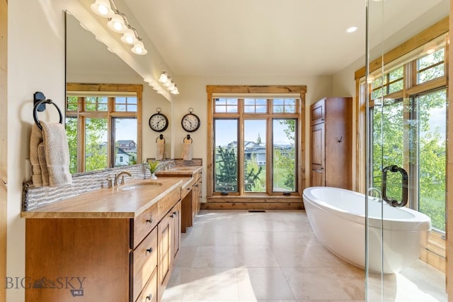 171 Brave Heart Loop, Bozeman, MT 59718 - bathroom featuring double vanity, a freestanding bath, and tile patterned flooring
