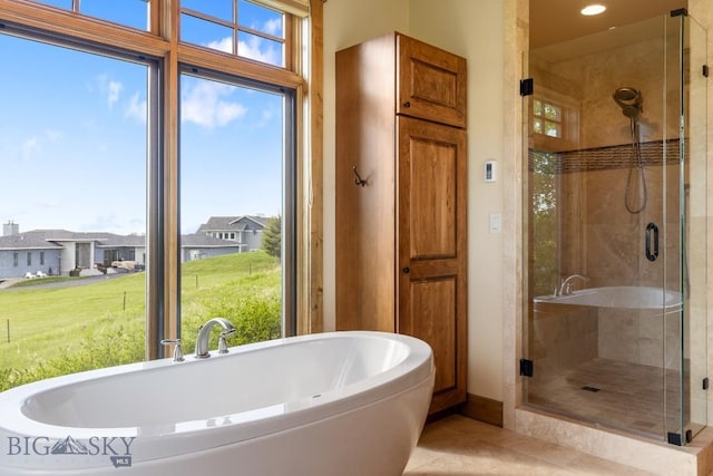 171 Brave Heart Loop, Bozeman, MT 59718 - bathroom featuring a soaking tub, a shower stall, tile patterned floors, and plenty of natural light