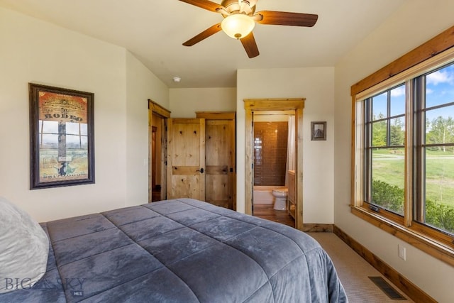 171 Brave Heart Loop, Bozeman, MT 59718 - carpeted bedroom featuring baseboards, ensuite bath, and ceiling fan