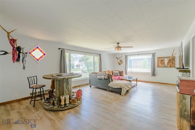 602 1st Ave E, Three Forks, MT 59752 - living room with plenty of natural light, wood finished floors, ceiling fan, and baseboards