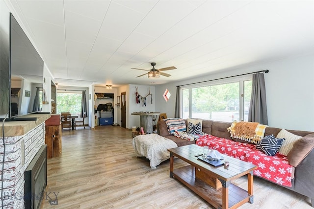 602 1st Ave E, Three Forks, MT 59752 - living room featuring healthy amount of natural light, light wood-type flooring, a ceiling fan, and a fireplace
