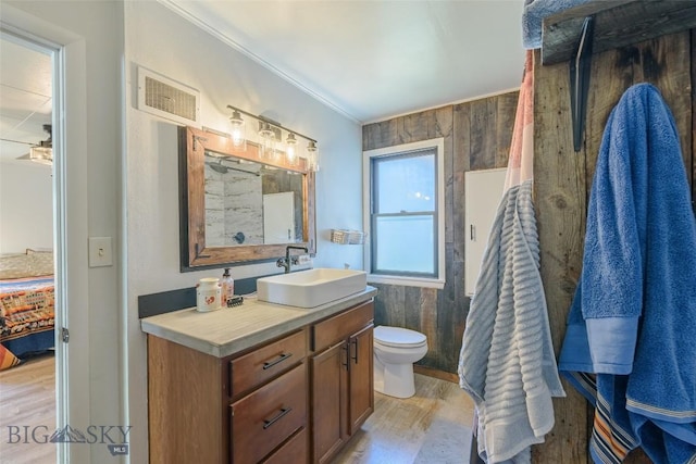 602 1st Ave E, Three Forks, MT 59752 - ensuite bathroom with wood finished floors, vanity, toilet, and crown molding