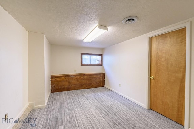 602 1st Ave E, Three Forks, MT 59752 - empty room with a textured ceiling, baseboards, and carpet