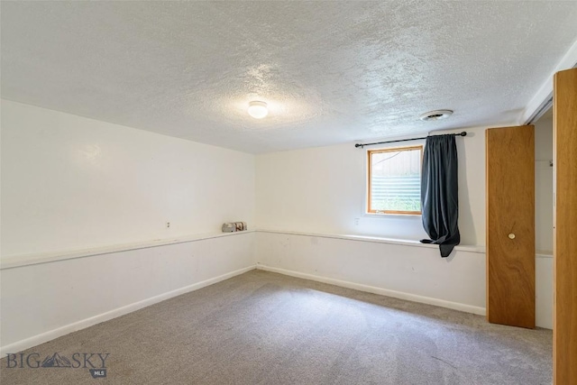 602 1st Ave E, Three Forks, MT 59752 - empty room with carpet, a textured ceiling, and baseboards