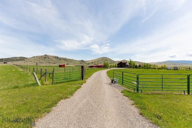 49 Redtail Hawk Rd, Mcallister, MT 59740 - view of dirt / gravel road featuring a view of rural / pastoral area, a gated entry, and a mountain view