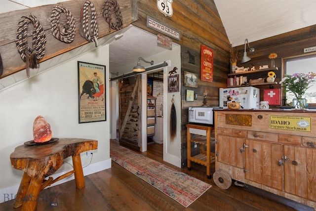 49 Redtail Hawk Rd, Mcallister, MT 59740 - kitchen with lofted ceiling, a barn door, white appliances, wood finished floors, and open shelves