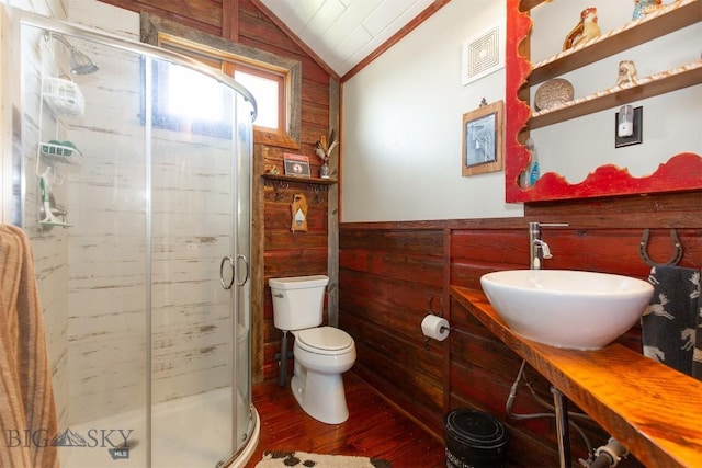49 Redtail Hawk Rd, Mcallister, MT 59740 - bathroom featuring lofted ceiling, wooden walls, wood finished floors, a stall shower, and toilet