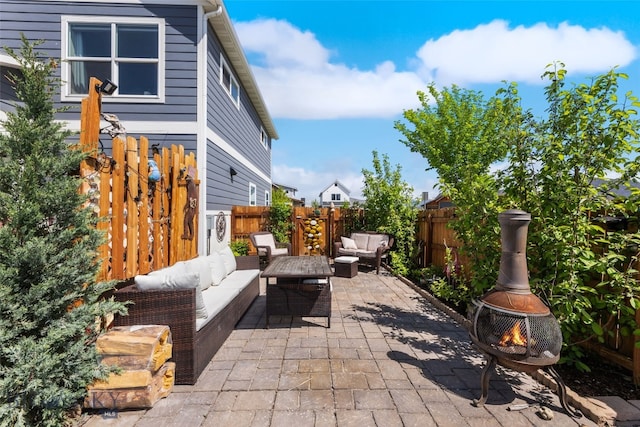 4426 Ethan Way, Bozeman, MT 59718 - fenced backyard with an outdoor living space with a fire pit and a patio area