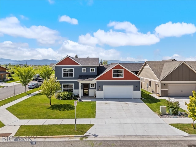 4426 Ethan Way, Bozeman, MT 59718 - view of front of house with concrete driveway, a garage, a front yard, board and batten siding, and a mountain view