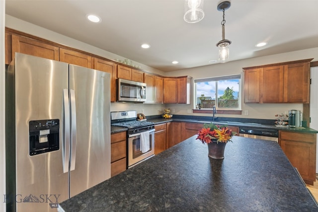 4426 Ethan Way, Bozeman, MT 59718 - kitchen featuring appliances with stainless steel finishes, a sink, brown cabinetry, hanging light fixtures, and recessed lighting