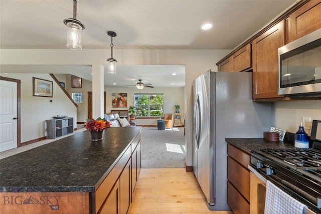 4426 Ethan Way, Bozeman, MT 59718 - kitchen with appliances with stainless steel finishes, brown cabinetry, a ceiling fan, open floor plan, and recessed lighting