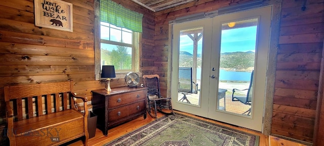 747 Upper Ruby Rd, Alder, MT 59755 - doorway to outside featuring french doors, wood walls, light wood-style flooring, and a mountain view