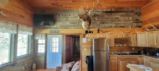 747 Upper Ruby Rd, Alder, MT 59755 - kitchen with freestanding refrigerator, wood walls, light brown cabinetry, a sink, and wood ceiling
