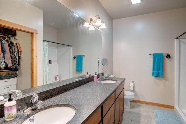 20 Voyager Ln Unit B, Bozeman, MT 59718 - bathroom featuring double vanity, curtained shower, baseboards, and toilet