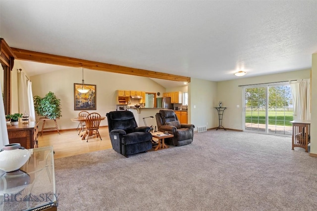 125 N Pheasant Dr, Bozeman, MT 59718 - living room featuring light carpet, baseboards, and vaulted ceiling