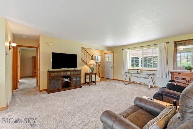 125 N Pheasant Dr, Bozeman, MT 59718 - living room featuring stairs, baseboards, and carpet