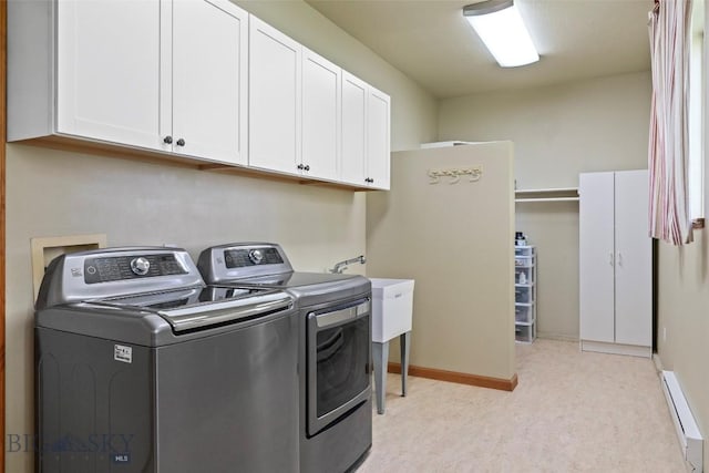 125 N Pheasant Dr, Bozeman, MT 59718 - washroom featuring cabinet space, a baseboard radiator, washing machine and dryer, light carpet, and baseboards