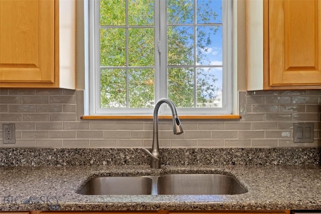 125 N Pheasant Dr, Bozeman, MT 59718 - kitchen featuring a sink, decorative backsplash, dark stone counters, and light brown cabinetry