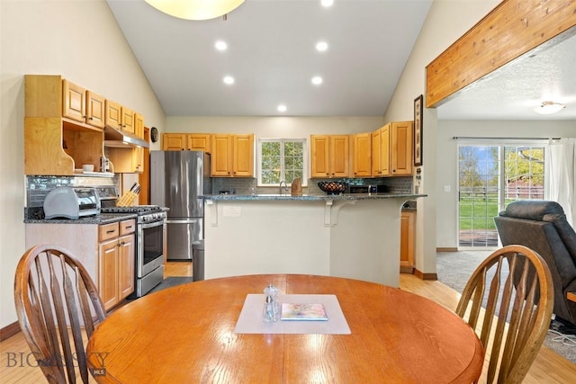 125 N Pheasant Dr, Bozeman, MT 59718 - kitchen with stainless steel appliances, backsplash, under cabinet range hood, a kitchen island, and recessed lighting