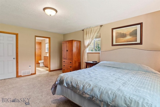 125 N Pheasant Dr, Bozeman, MT 59718 - bedroom featuring light colored carpet, connected bathroom, baseboards, and a textured ceiling