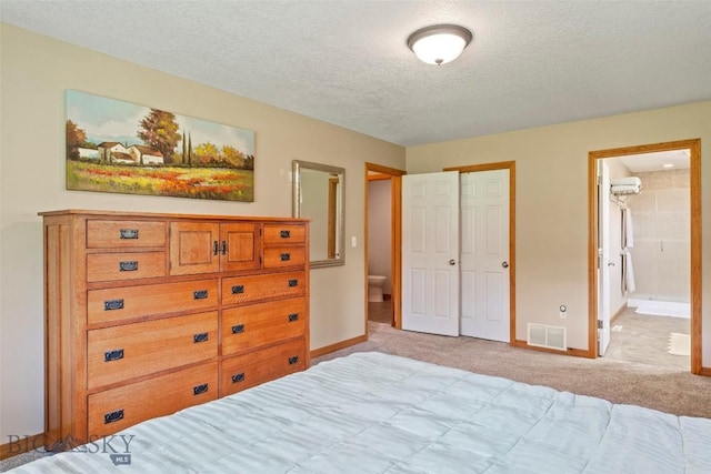 125 N Pheasant Dr, Bozeman, MT 59718 - bedroom featuring light colored carpet, a textured ceiling, baseboards, and connected bathroom